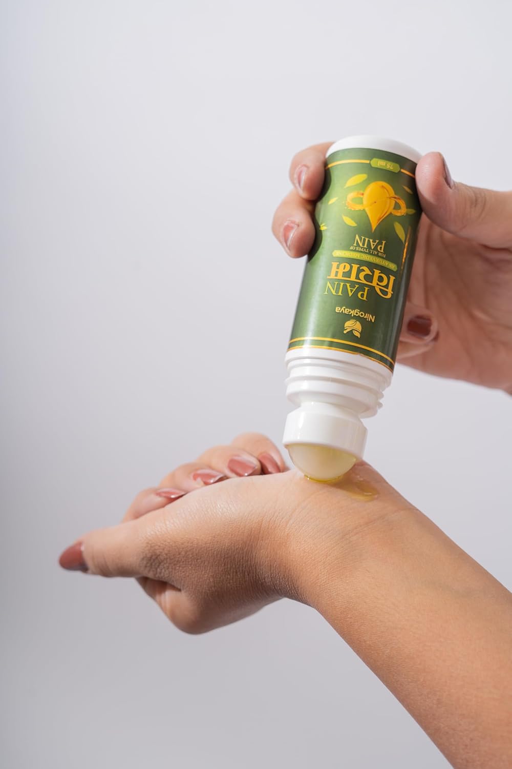 Applying Pain Viram Herbal Massage Oil on Muscle for Fast Relief